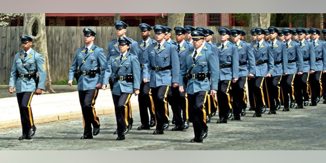 A new lawsuit alleges the State Police was pressured into accepting more racially diverse candidates for the police academy.