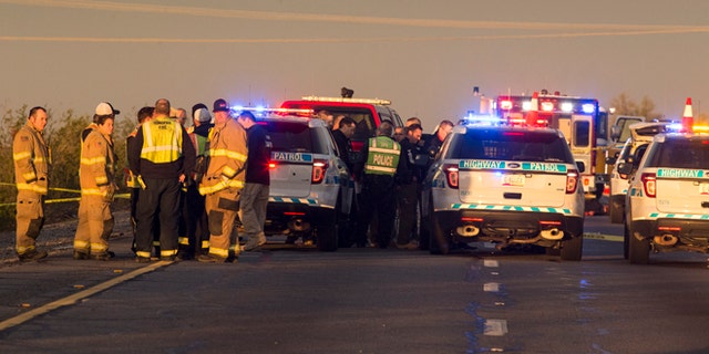 Emergency personnel gather at the scene where an Arizona Department of Public Safety trooper was shot, Thursday, Jan. 12, 2017, at the scene of a rollover accident on Interstate 10 near Tonopah, Ariz.