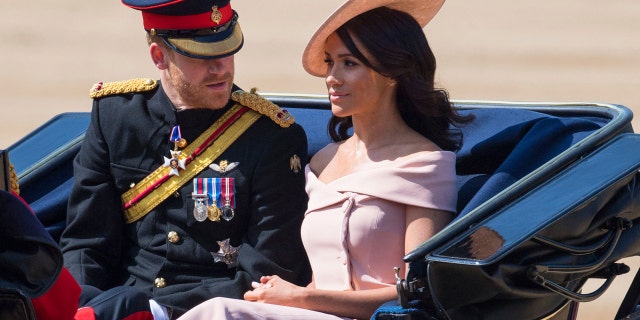 The Duke and Duchess of Sussex ride in the Trooping of the Coulors military parade before heading into Buckingham Palace.