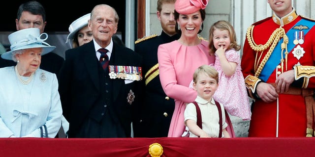 From left, Britain's Queen Elizabeth II, Prince Philip, the Duke of Edinburgh, Kate, The Duchess of Cambridge, Prince William and their children Prince George and Princess Charlotte appear on the balcony of Buckingham Palace, after attending the annual Trooping the Colour Ceremony in London, Saturday, June 17, 2017. Prince Harry is in the background. (AP Photo/Kirsty Wigglesworth)