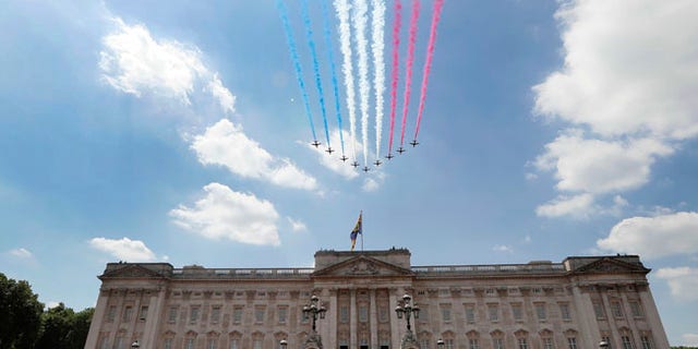The Red Arrows fly past as Britain's Royals watch from the balcony of Buckingham Palace, after the annual Trooping the Colour Ceremony in London, Saturday, June 17, 2017. (AP Photo/Kirsty Wigglesworth)