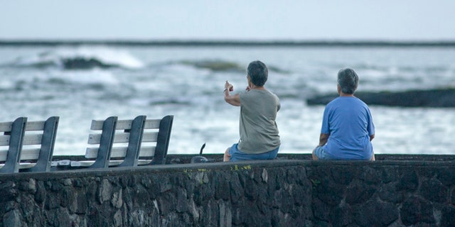Aug. 31: Jeri, left, and Jen Nakano, both from Hilo, sit near the ocean in Hilo, Hawaii.