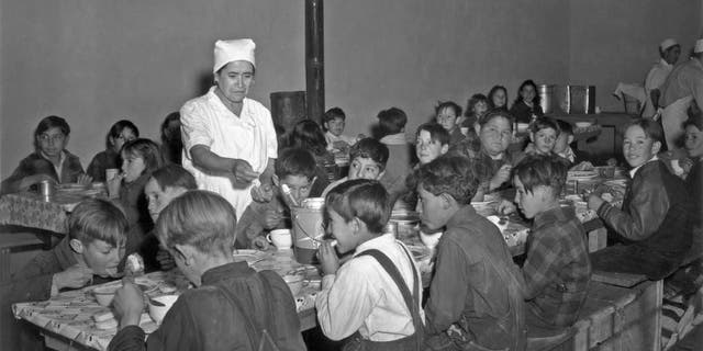 The hot lunch, school at Penasco. Childred pay about once cent daily for this hot meal made up primarily of food from the surpus commodities program, and prepared by WPA paid cooks December 1941 in Taos Co, NM.