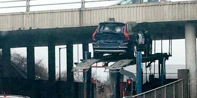 This picture shows the moment a car got stuck under a bridge while on top of a transporter. See CENTRE PRESS story CPCAR. Kirsty Adams was driving from her granddadâs funeral at around 3pm on Thursday until she witnessed "a Volvo" trapped underneath the bridge. According to the 33-year-old, another car fell to the ground as the transporter attempted to drive under the low bridge. The incident which happened near a roundabout at the Hillington Industrial Estate in Glasgow left the mother-of-one and her partner stunned.