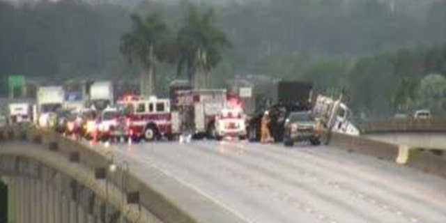 Traffic was backed of for miles after the truck become suspended halfway over an overpass.