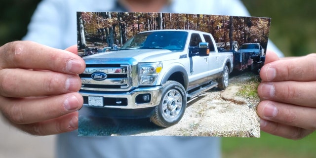 Gerardo Serrano showing a photo of his seized truck.