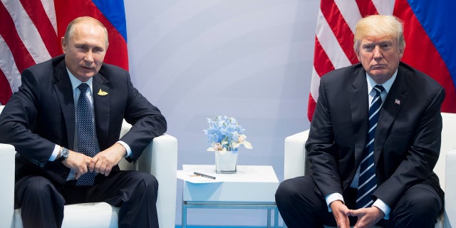 FILE - In this July 7, 2017, file photo, U.S. President Donald Trump, right, and Russian President Vladimir Putin pose for a photo during the G20 summit in Hamburg Germany. (AP Photo/Marcellus Stein, File)