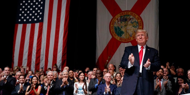 June 16, 2017: President Donald Trump applauds as he arrives to speak about Cuba policy in Miami. The president announced changes to Obama-era Cuba policy, and challenged the Castro government to negotiate a better deal.