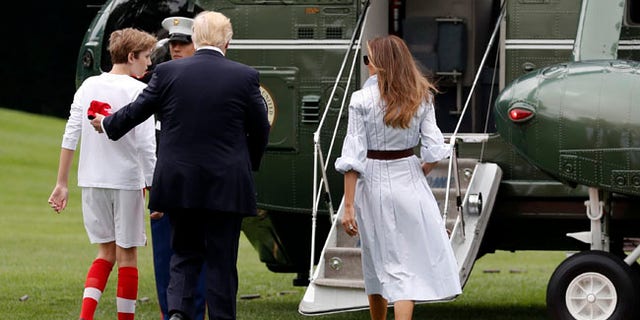 President Donald Trump, first lady Melania Trump, and their son and Barron Trump, board Marine One on the South Lawn of the White House in Washington, Saturday, June 17, 2017, en route to Camp David in Maryland. (AP Photo/Carolyn Kaster)