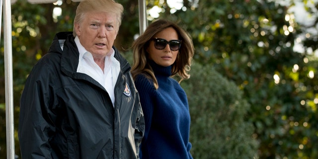 President Donald Trump, accompanied by first lady Melania Trump, walks to board Marine One on the South Lawn of the White House in Washington, Tuesday, Oct. 3, 2017. (AP Photo/Andrew Harnik)
