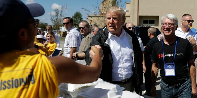 President Trump shakes hands with a volunteer at the Temple Baptist Church in New Bern, N.C. Wednesday.