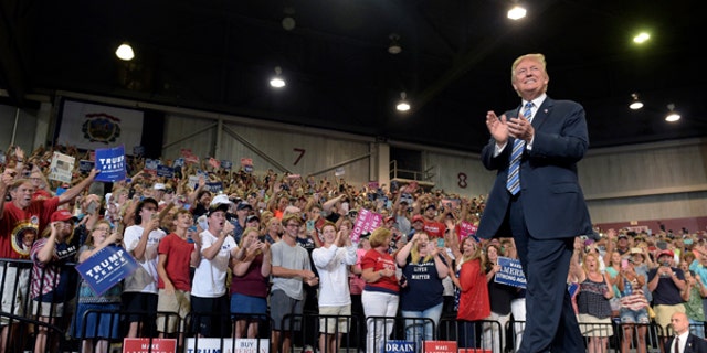 In this Aug. 3, 2017, photo, President Donald Trump arrives to speak at a campaign-style rally at Big Sandy Superstore Arena in Huntington, W.Va. After six months of infighting, investigations and legislative failures, President Donald Trump is trying to combat new signs of weakness in his Republican base and re-energize his staunchest supporters. White House officials have been urging the president to refocus on immigration and other issues that resonate with the conservatives, evangelicals and working-class whites who propelled him to the Oval Office. The president has ramped up his media-bashing via Tweet, long a successful tactic for Trump, and asked his base to rally to his defense.(AP Photo/Susan Walsh)