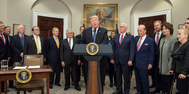 President Donald Trump speaks before signing the Presidential Space Directive - 1, directing NASA to return to the moon, in the Roosevelt room of the White House on Dec. 11, 2017.