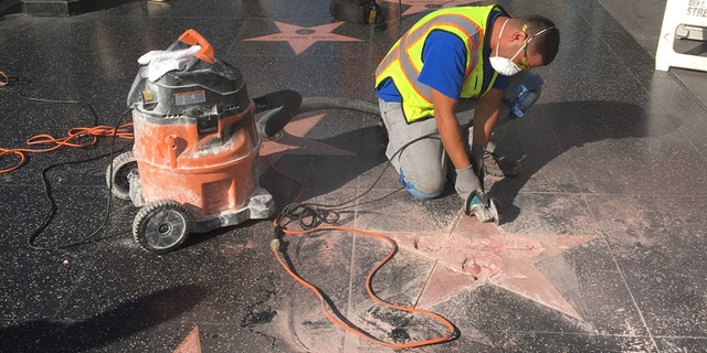 A repair worker tends to Donald Trump's destroyed star on the Hollywood Walk of Fame.