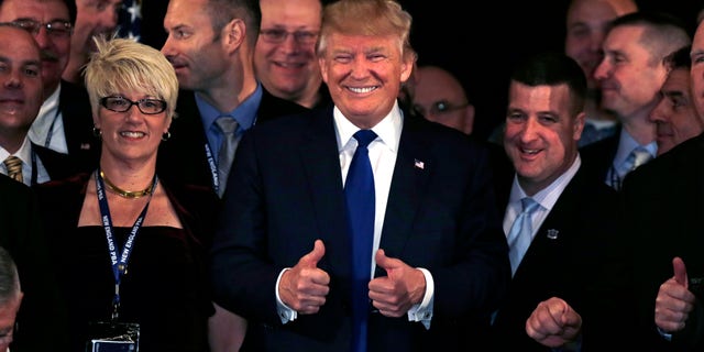 Dec. 10, 2015 - Republican presidential candidate Donald Trump flashes thumbs up after being endorsed at a regional police union meeting in Portsmouth, N.H. (AP)