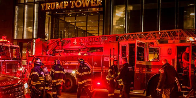 Firefighters work outside Trump Tower in New York City, April 7, 2018.