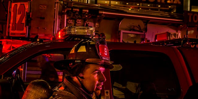 A firefighter works in front of Trump Tower after a fire in New York, April 7, 2018.