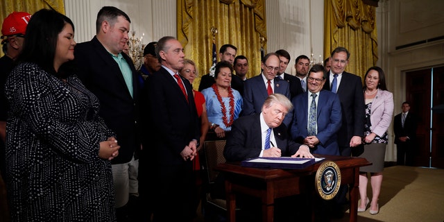 U.S. President Donald Trump signs the âVA Accountability Actâ during a signing ceremony  in the East Room of the White House in Washington, U.S., June 23, 2017. REUTERS/Jonathan Ernst - RTS18DQJ