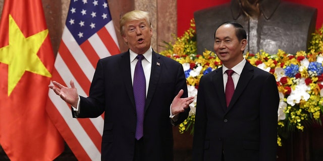 U.S. President Donald Trump (L) gestures as he poses with his Vietnamese counterpart Tran Dai Quang during a welcoming ceremony at the Presidential Palace in Hanoi, Vietnam November 12, 2017. Trump has high approval ratings in Vietnam.