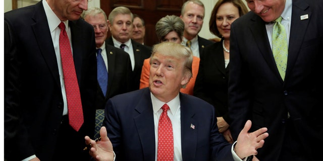 U.S. President Donald Trump greets guests after signing the water executive order at the White House, in Washington, DC, U.S. February 28, 2017.