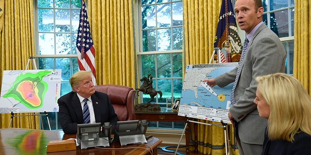 President Trump listens as FEMA Administrator Brock Long, center, talks about Hurricane Florence in the Oval Office of the White House on Tuesday with Homeland Security Secretary Kirstjen Nielsen, right.
