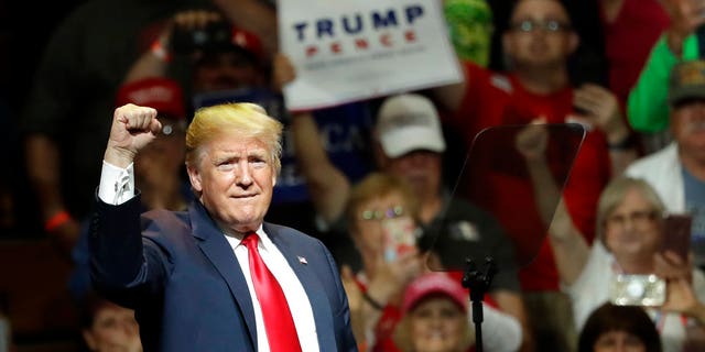 President Donald Trump acknowledges the crowd's applause during a Republican campaign rally Thursday, May 10, 2018, in Elkhart, Ind. (AP Photo/Charles Rex Arbogast)