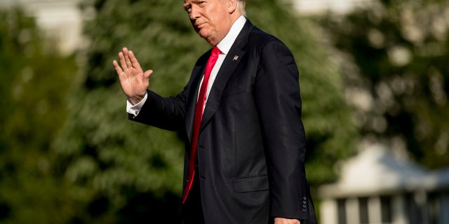 President Donald Trump walks across the South Lawn of the White House, April 28, 2017.