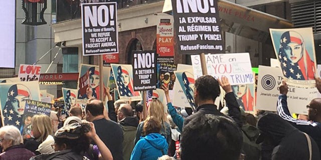 Protesters hold signs at the "I Am A Muslim Too" rally.