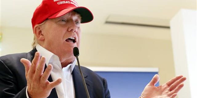 FILE - In this July 30, 2015 file photo, Republican presidential candidate Donald Trump speaks to the media during a news conference on the first day of the Women's British Open golf championship on the Turnberry golf course in Turnberry, Scotland. Republican presidential candidates dismissed Trump's dominance in early primary polling, scrambling to position themselves days before their first debate. (AP Photo/Scott Heppell, File)