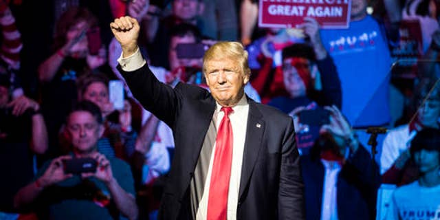 Republican presidential candidate Donald Trump waves to a crowd during a campaign rally, Thursday, Oct. 13, 2016, Cincinnati. (AP Photo/John Minchillo)