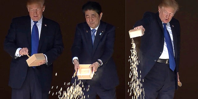 In this combination of images made from video, U.S. President Donald Trump and Japan's Prime Minister Shinzo Abe feed carp at a koi pond before their working lunch at Akasaka Palace in Tokyo, Japan Monday, Nov. 6, 2017. (AP Photo)