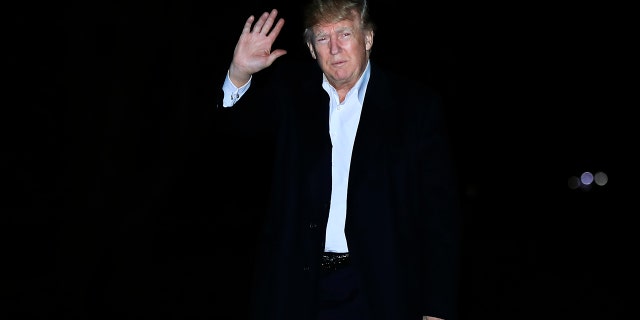 President Donald Trump waves as he walks on the South Lawn upon his return to the White House in Washington, from a five-nation Asia tour, Tuesday, Nov. 14, 2017.