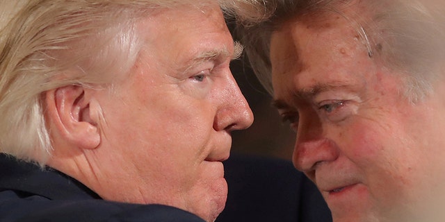 FILE PHOTO: U.S. President Donald Trump talks to chief strategist Steve Bannon during a swearing in ceremony for senior staff at the White House in Washington, U.S. January 22, 2017. REUTERS/Carlos Barria/FILE PHOTO TPX IMAGES OF THE DAY - RC11E229E6A0
