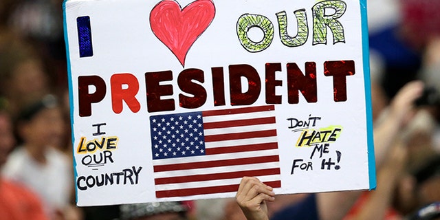 A supporter holds up a sign as President Donald Trump speaks at the Covelli Centre, Tuesday, July 25, 2017, in Youngstown, Ohio. (AP Photo/Tony Dejak)