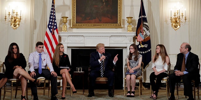 President Donald Trump speaks as he hosts a listening session with high school students, teachers and parents in the State Dining Room of the White House in Washington, Wednesday, Feb. 21, 2018. (AP Photo/Carolyn Kaster)