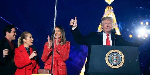 President Trump and first lady Melania Trump cheer after lighting the 2017 National Christmas Tree.