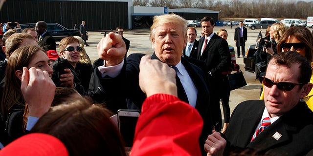 President Donald Trump greets supporters after arriving at Cincinnati Municipal Lunken Airport, Monday, Feb. 5, 2018, in Cincinnati. (AP Photo/Evan Vucci)