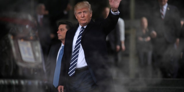 File photo - U.S. President Donald Trump waves as he leaves the Central Intelligence Agency (CIA) headquarters after delivering remarks during a visit in Langley, Virginia U.S., January 21, 2017. (REUTERS/Carlos Barria)