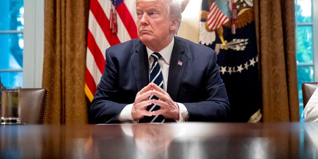 President Donald Trump waits for members of the media get set up before speaking in the Cabinet room of the White House, Tuesday, July 17, 2018, in Washington. Trump says he meant the opposite when he said in Helsinki that he doesn't see why Russia would have interfered in the 2016 U.S. elections.. (AP Photo/Andrew Harnik)