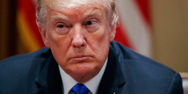 In this Feb. 28, 2018 photo, President Donald Trump pauses during a meeting in the Cabinet Room of the White House, in Washington, with members of congress to discuss school and community safety. A White House official says President Donald Trump plans to announce Thursday whether he'll impose tariffs or quotas on steel and aluminum imports. (AP Photo/Carolyn Kaster)