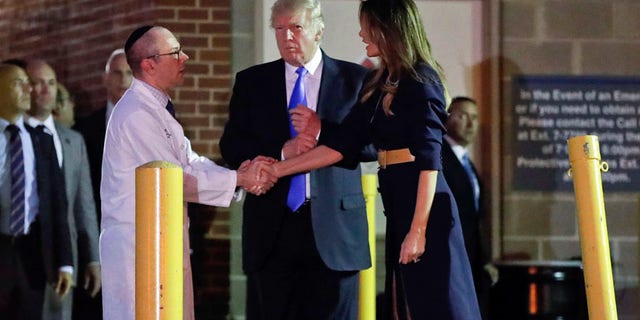 President Donald Trump and first lady Melania Trump with Dr. Ira Y. Rabin, left, after visiting MedStar Washington Hospital Center in Washington, Wednesday, June 14, 2017, where House Majority Leader Steve Scalise of La. was taken after being shot in Alexandria, Va., during a Republican congressional baseball practice. (AP Photo/Pablo Martinez Monsivais)