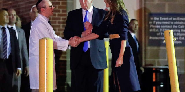 President Donald Trump and first lady Melania Trump with Dr. Ira Y. Rabin, left, after visiting MedStar Washington Hospital Center in Washington, Wednesday, June 14, 2017, where House Majority Leader Steve Scalise of La. was taken after being shot in Alexandria, Va., during a Republican congressional baseball practice. (AP Photo/Pablo Martinez Monsivais)