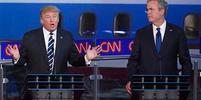 Republican presidential candidate, businessman Donald Trump, left, speaks as Jeb Bush looks on during the CNN Republican presidential debate at the Ronald Reagan Presidential Library and Museum on Wednesday, Sept. 16, 2015, in Simi Valley, Calif. (AP Photo/Mark J. Terrill)
