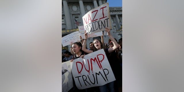 FILE - In this Nov. 10, 2016, file photo, Mission High School students Hope Robertson, right, yells as she protests with other high school students in opposition of Donald Trump's presidential election victory in front of City Hall in San Francisco.