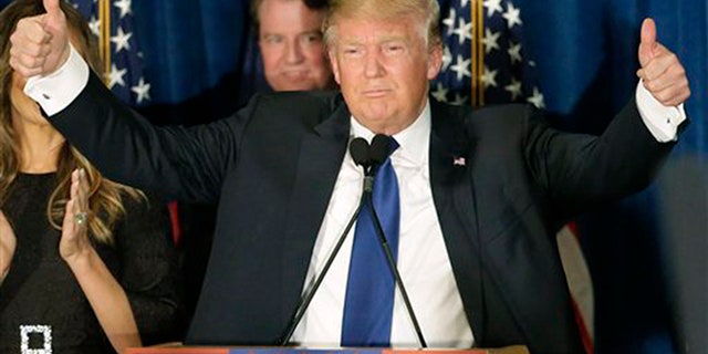 Republican presidential candidate, businessman Donald Trump gives thumbs up to supporters during a primary night rally, Tuesday, Feb. 9, 2016, in Manchester, N.H. (AP Photo/David Goldman)