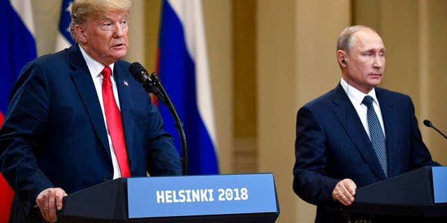 U.S. President Donald Trump speaks as Russian President Vladimir Putin listens during a join press conference at the Presidential Palace in Helsinki, Finland, Monday, July 16, 2018. (Antti Aimo-Koivisto/Lehtikuva via AP)