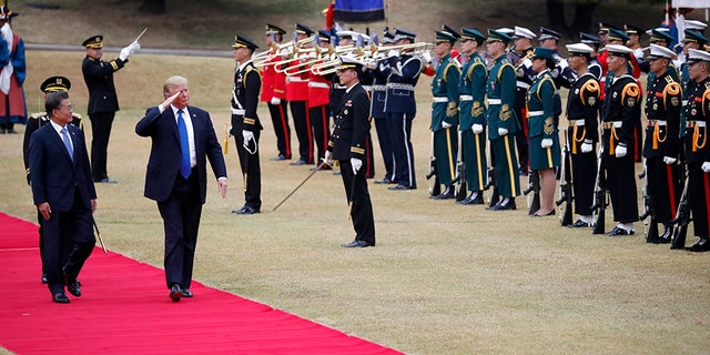 President Trump walks with South Korea's President Moon Jae-in during a welcoming ceremony at the Presidential Blue House in Seoul Tuesday, Nov. 7, 2017.