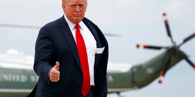 FILE - President Donald Trump gives the go-ahead as he boards Air Force One.