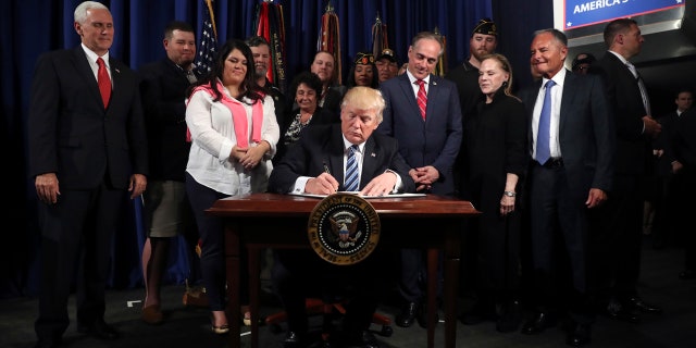 President Donald Trump signs an Executive Order on "Improving Accountability and Whistleblower Protection" at the Department of Veterans Affairs, Thursday, April 27, 2017, in Washington.