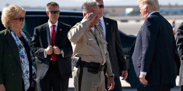 Clark County Sheriff Joseph Lombardo salutes President Donald Trump after he arrived at Las Vegas McCarran International Airport to meet with victims and first responders of the mass shooting.